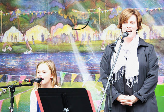 Girl and teacher singing at The Arts Center for All Recital